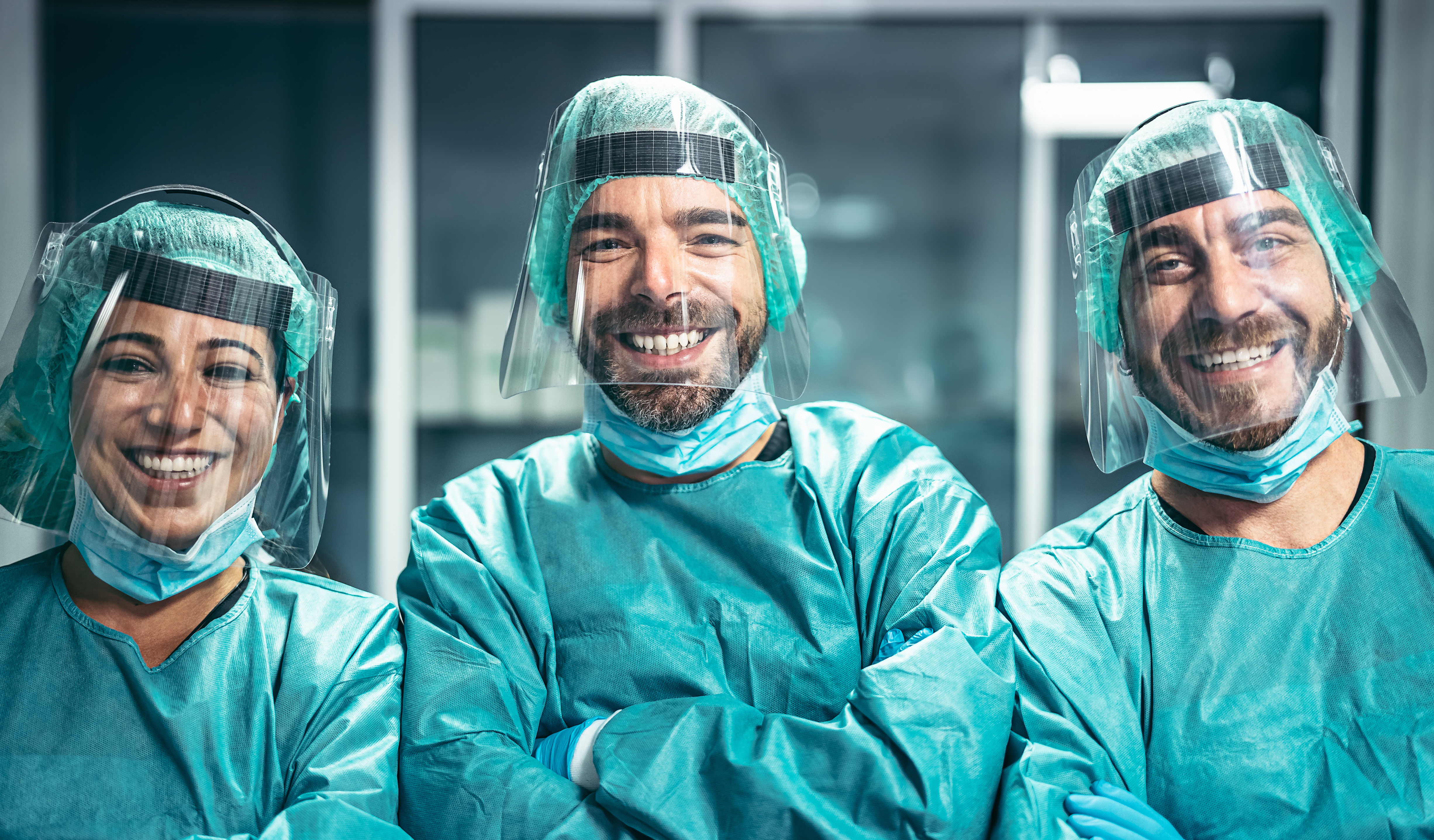 Surgeons smiling after a surgical operation