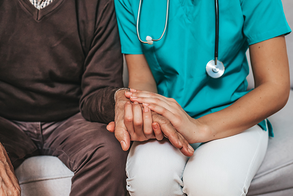 Image of healthcare worker holding patient hand