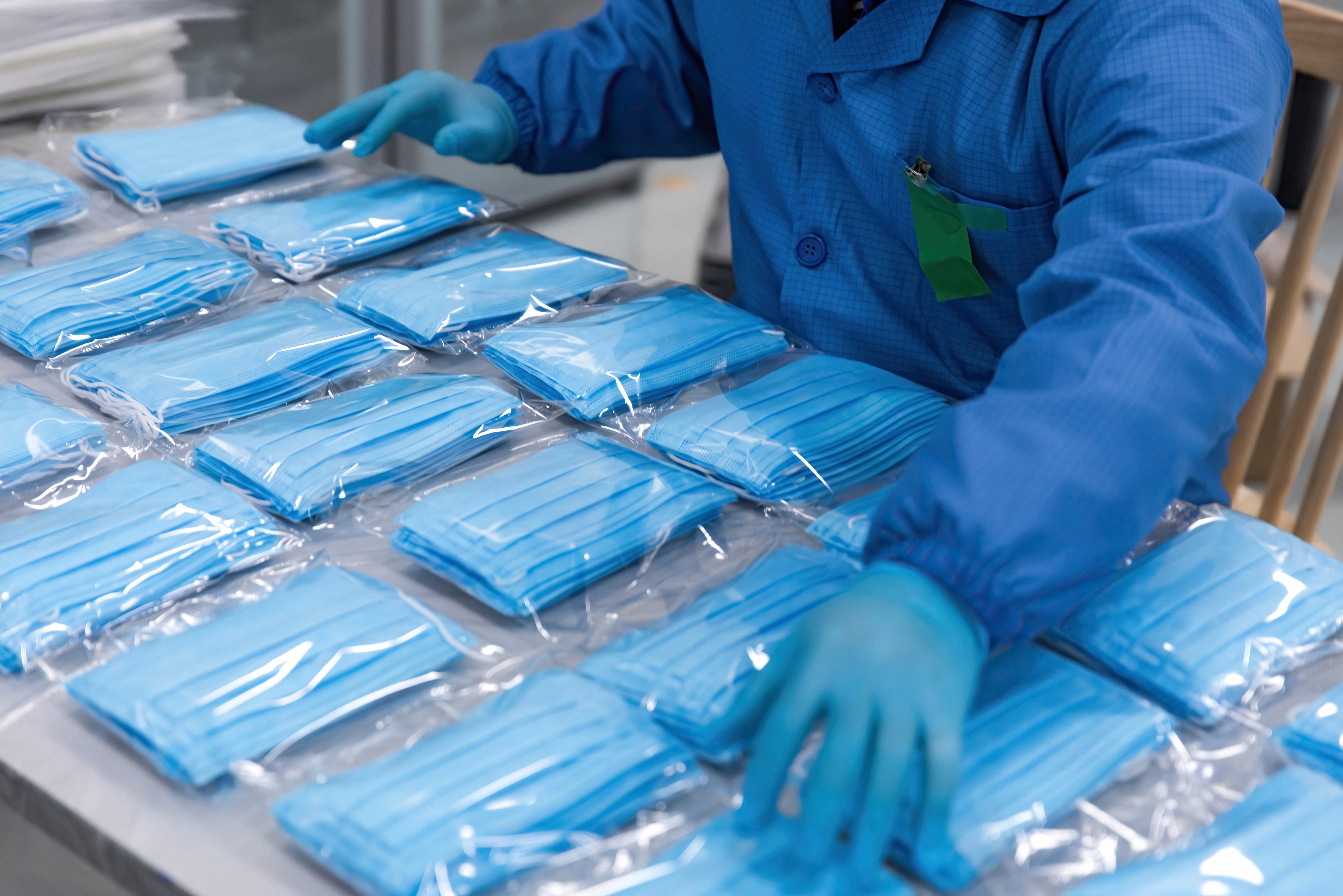 Healthcare professional packaging up face masks. 