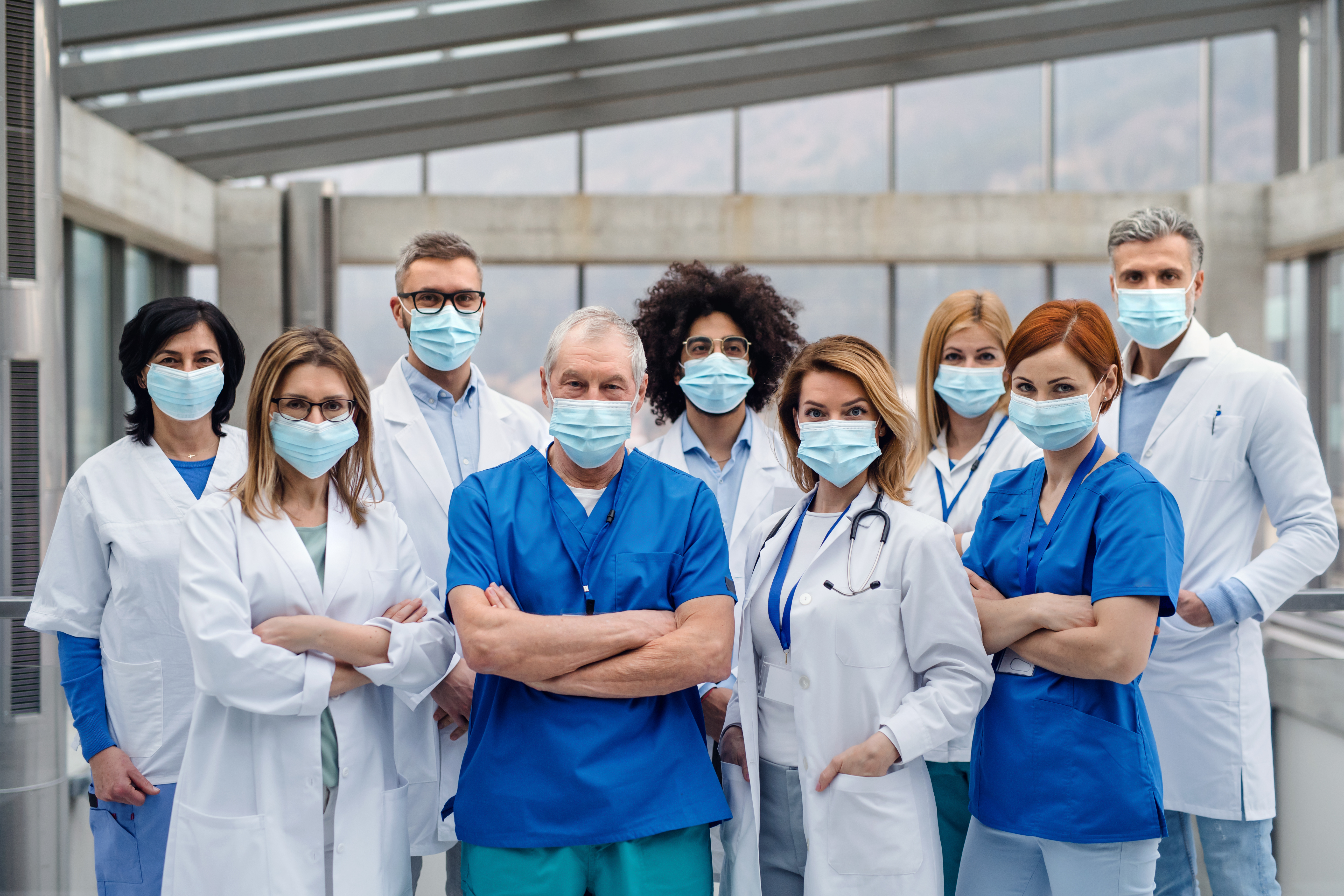 Group of doctors with face masks looking at camera,