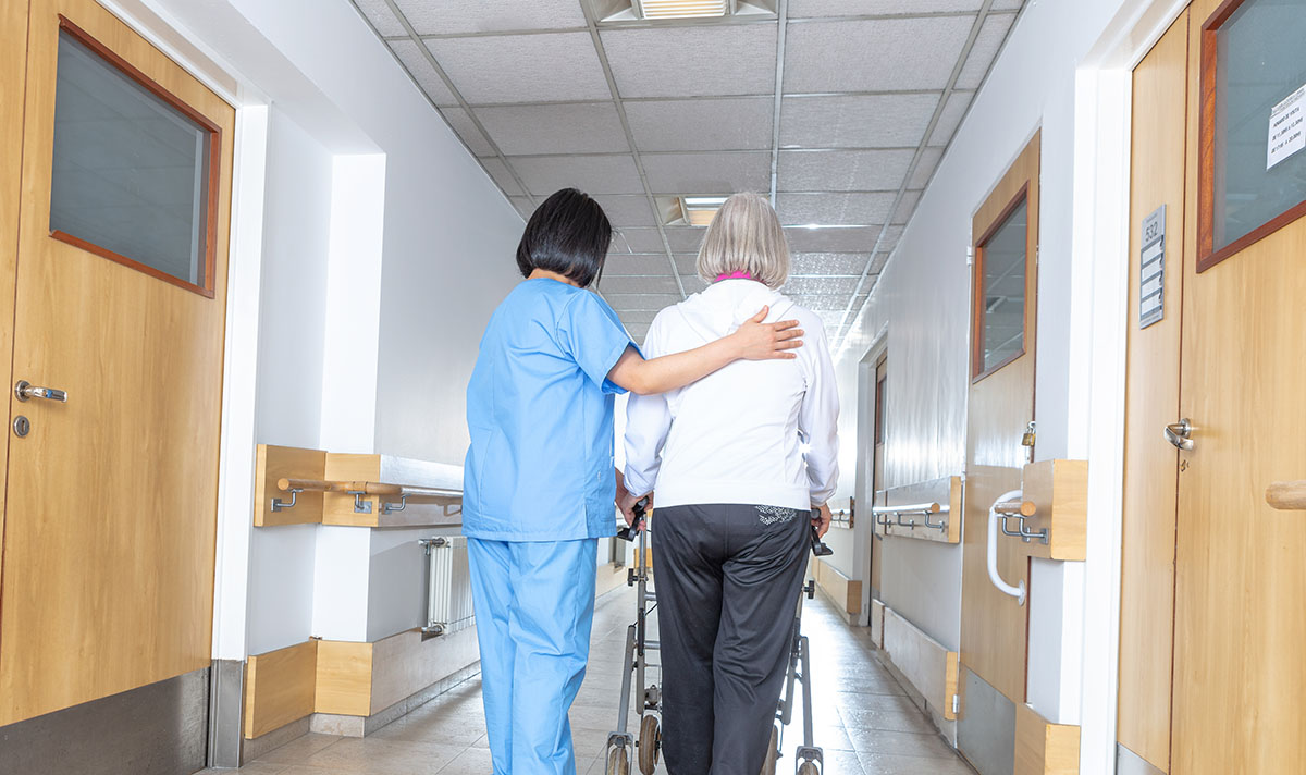 Image of nursing walking with patient 