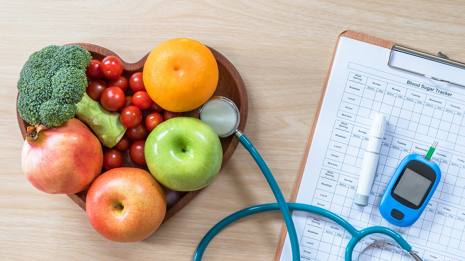 diabetes monitor next to a heart-shaped fruit basket