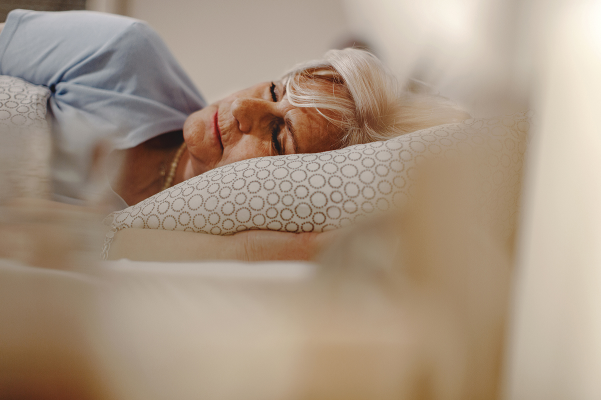 Senior woman resting while sleeping in bed.