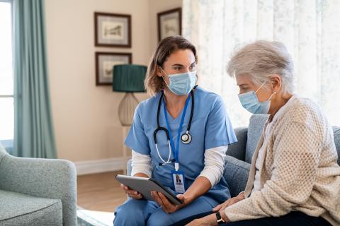 Nurse and patient looking over information on a tablet