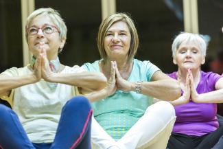 Group of three elderly woman in yoga class