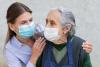 Caregiver and nursing home resident with masks