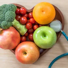 diabetes monitor next to a heart-shaped fruit basket