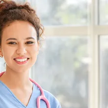 Image of female clinician holding a chart