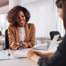 Image of African-American female consultant speaking with a client 