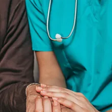 Image of healthcare worker holding patient hand