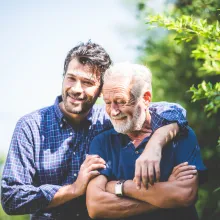 Two generations of men in outdoor setting