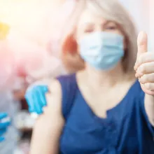 Doctor giving a senior woman a vaccination. Virus protection. COVID-19.