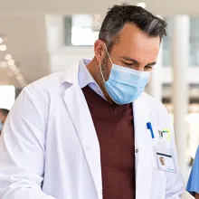 Male doctor talking to female nurse