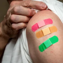 Senior caucasian man sleeve to show the third booster coronavirus vaccine shot in the shoulder.