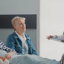 Doctor talking to patient and their family in patients room