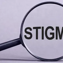 Magnifying glass with the word stigma displayed