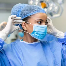 Clinician putting on face mask