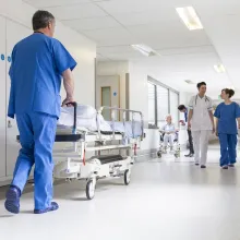 Doctors Hospital Corridor Nurse Pushing Gurney Stretcher Bed