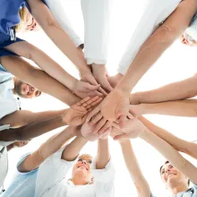 Directly below shot of multiethnic medical team stacking hands over white background