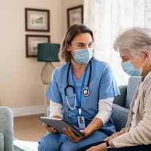 Nurse and patient looking over information on a tablet