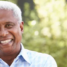 Smiling senior African American man with arms crossed