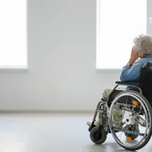 Lonely senior woman in wheelchair indoors
