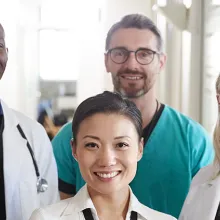 Portrait Of Medical Team Standing In Hospital Corridor.