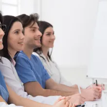 Group of male and female providers sitting and watching lecture