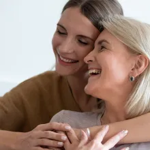 Closeup adult daughter hugs elderly mother enjoy tender moment