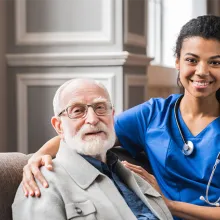 Clinician sitting with elderly patient