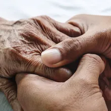 Image of 2 people holding hands