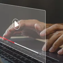 African American male watching video on laptop with play button on the screen