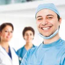 Smiling clinician in front of his team