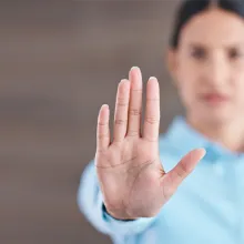 Woman holding up her hand in a stop motion