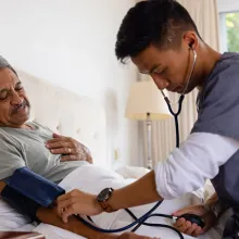 Image of someone taking a patient's blood pressure