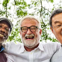 Image of culturally diverse seniors smiley at camera.