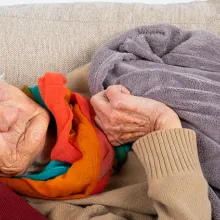 Elderly person laying on couch