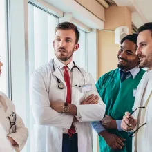 Health care providers talking in the hallway of a health care facility.