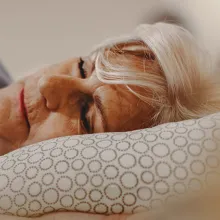 elderly person sleeping in bed