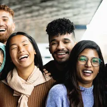 Young multi ethnic friends having fun together hanging out in the city 