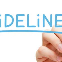 Image of a male hand with blue marker writing the word 'Guidelines' on a whiteboard.