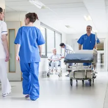 Colleagues conversing in hospital corridor