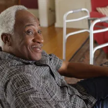 Elderly man sitting and smiling