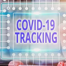 Photo of person holding a COVID-19 Tracking sign