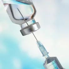 needle going into vaccine vile 