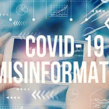 person holding digital display that says 'COVID-19 misinformation'