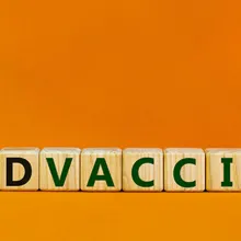 Hand turns cubes and changes words 'covid vaccine myths' to 'covid vaccine facts'