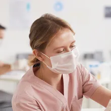 clinician giving elderly patient a shot