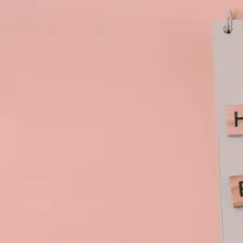 Message health equity with wooden letters on notebook with pink background