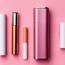 a variety of tobacco products in front of a pink background